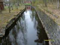 Den stensatta kanal �ster om str�mmen som ledde fram till hyttan och bl�strarna.
