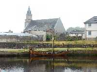 Hamnen i Ardrishaig. Nedanf�r kyrkan ligger ett vikingaskepp f�rt�jt.